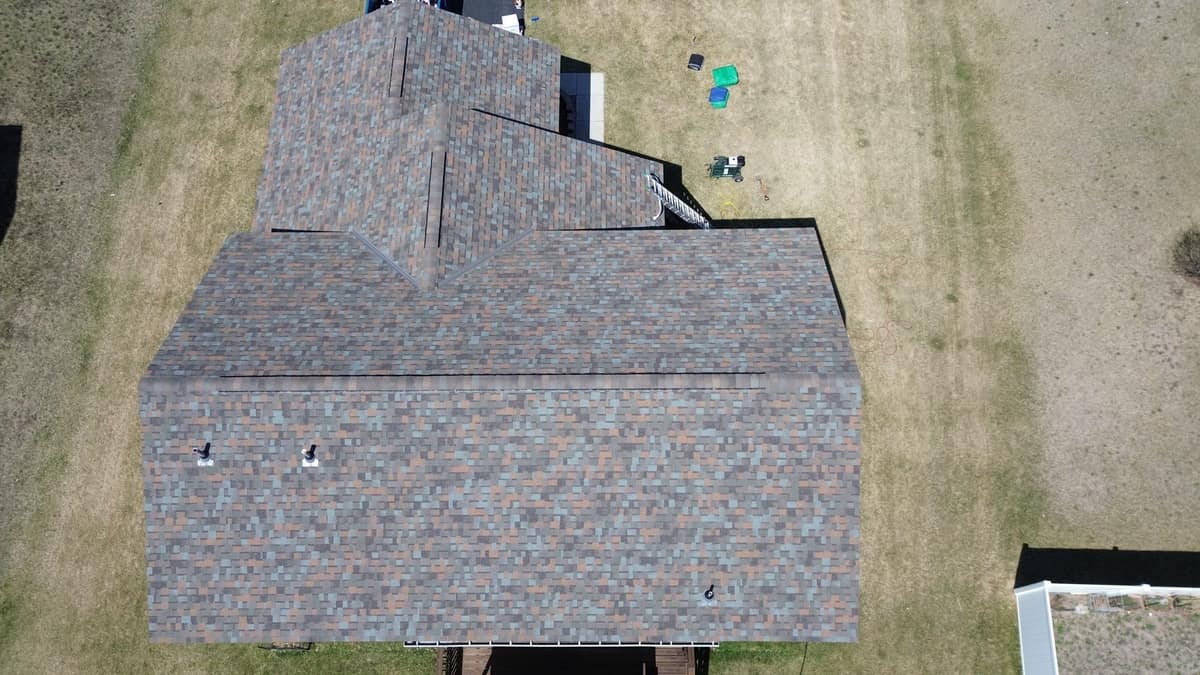 Top-down drone view of a new multi-tone architectural shingle roof in Big Lake, MN