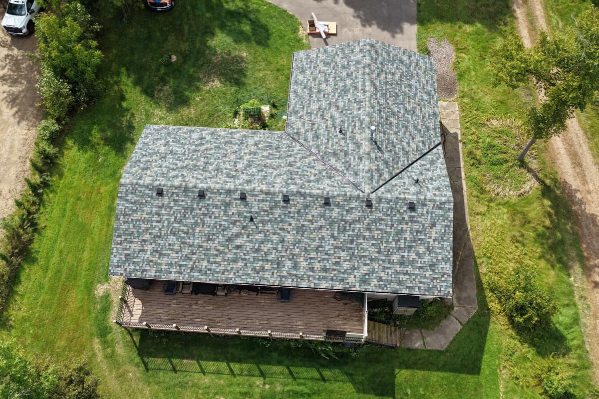 Drone view of a new shingle roof on an L-shaped home in Brainerd, MN