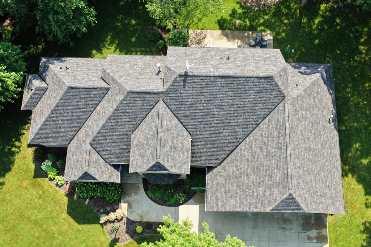 Drone view of a new brown architectural shingle roof on a large home in Cold Spring, MN