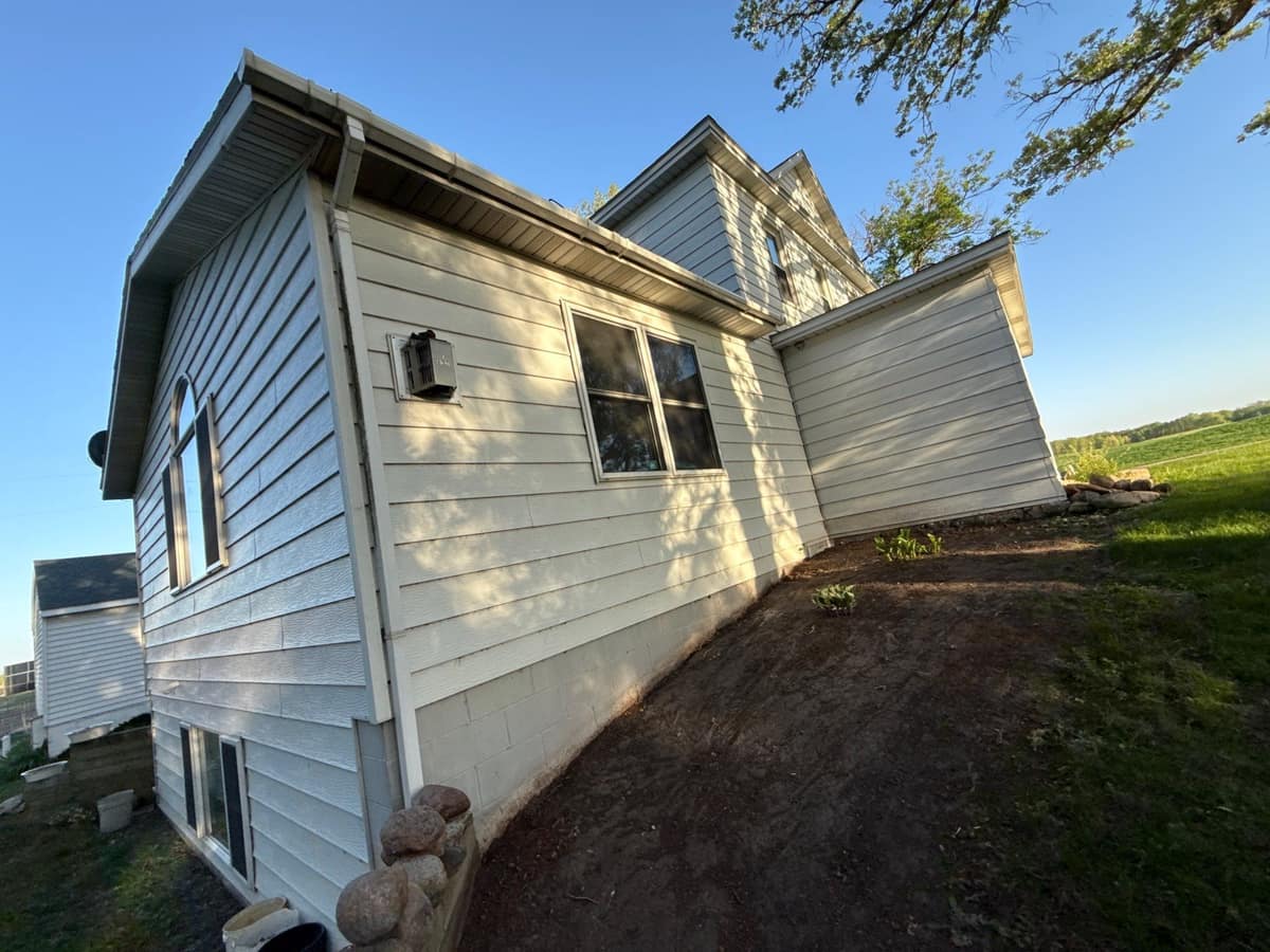 Cream lap siding with white gutters and downspouts on a home in Kimball, MN