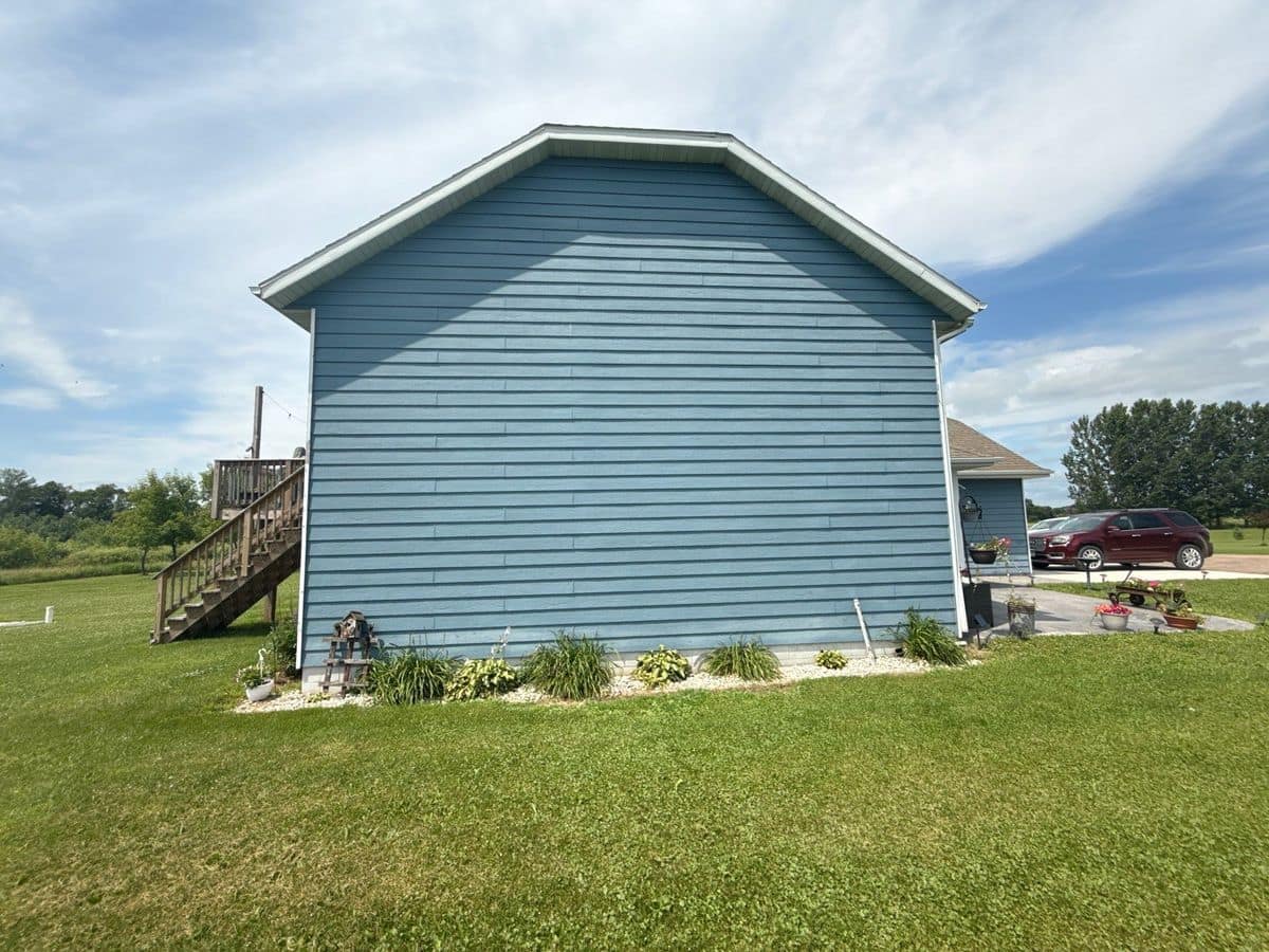 Blue lap siding on the gable end of a home in Milaca, MN