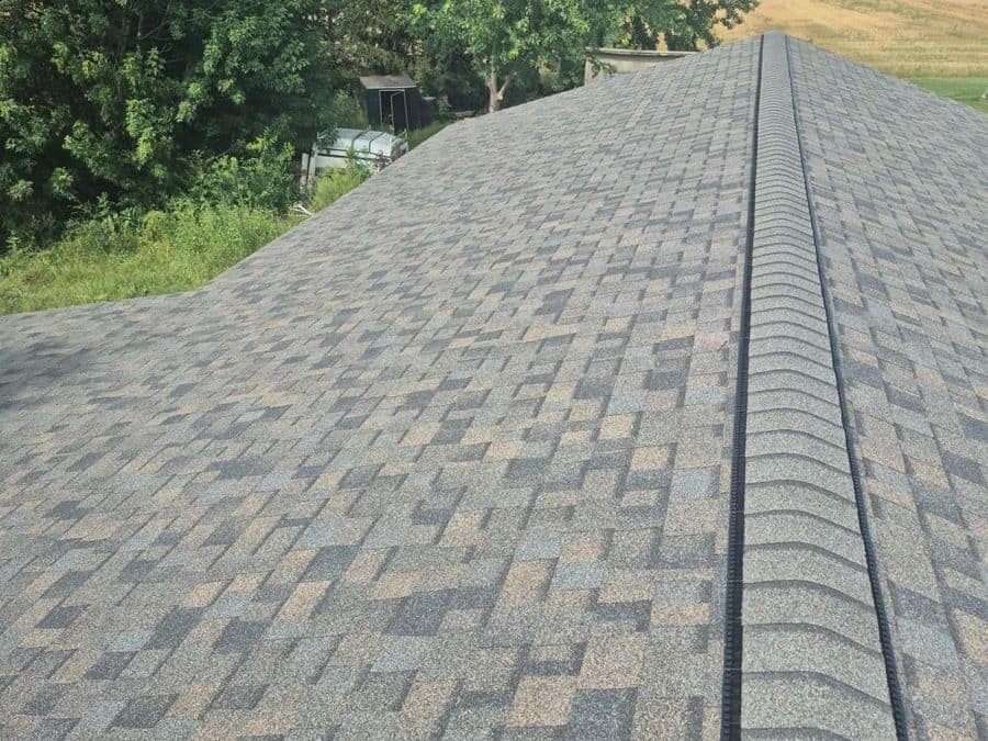 New gray architectural shingle roof with a ridge vent in Milaca, MN