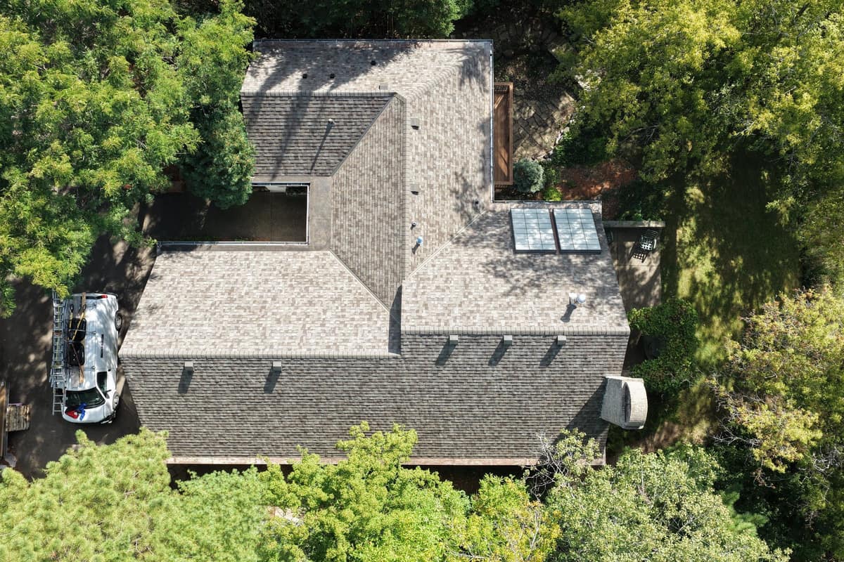 Top-down drone view of a new shingle roof with a pair of skylights in Minnetonka, MN