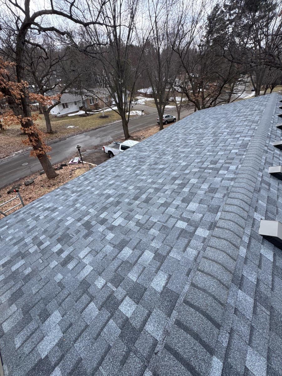 Finished blue-gray shingle roof with ridge vents in Minnetonka, MN