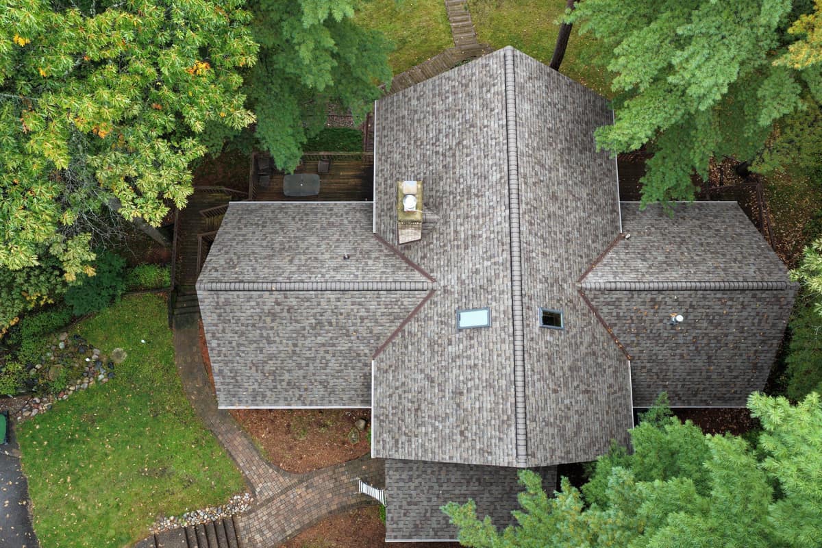 Top-down drone view of a new shingle roof with skylights in Nisswa, MN