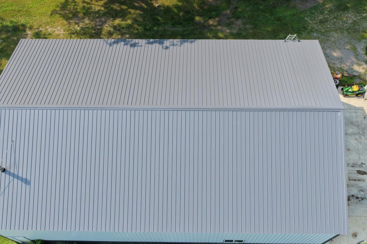 Top-down drone view of a gray metal roof on a shop building in Paynesville, MN