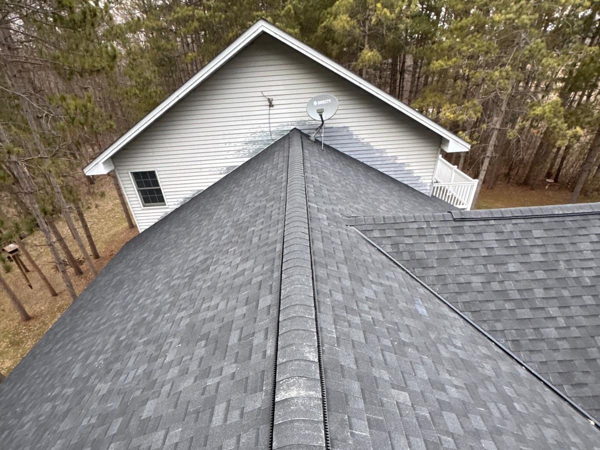Shingle roof ridge with ridge vent on a home in the woods in Richmond, MN
