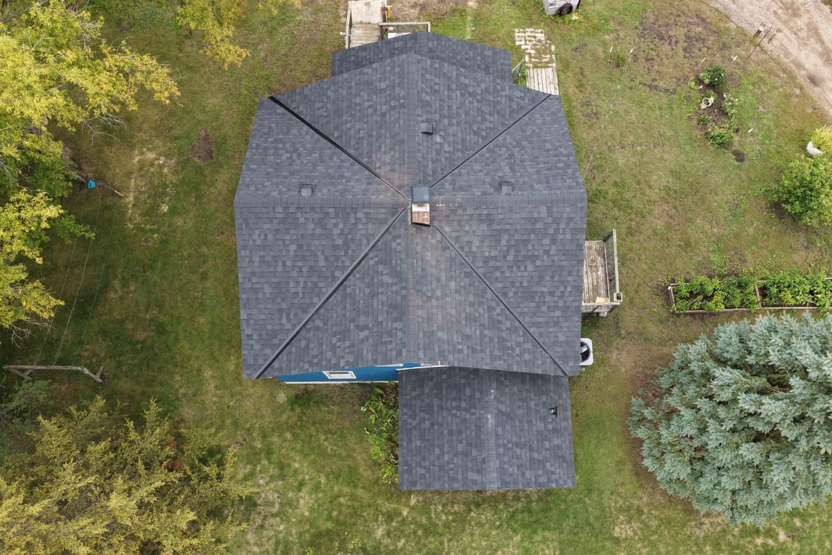 Top-down drone view of a new charcoal hip roof in Sartell, MN