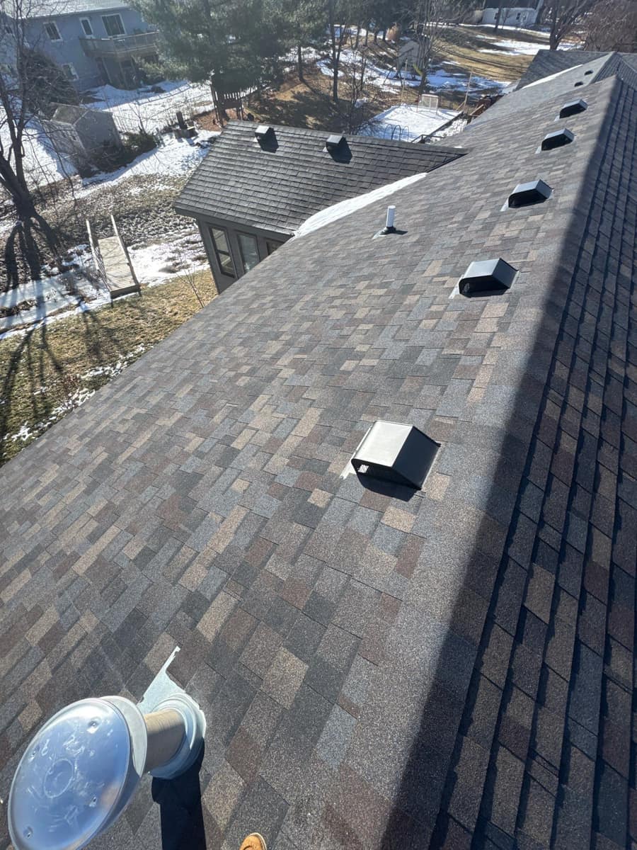 Finished shingle roof with box vents along the ridge in Sauk Rapids, MN