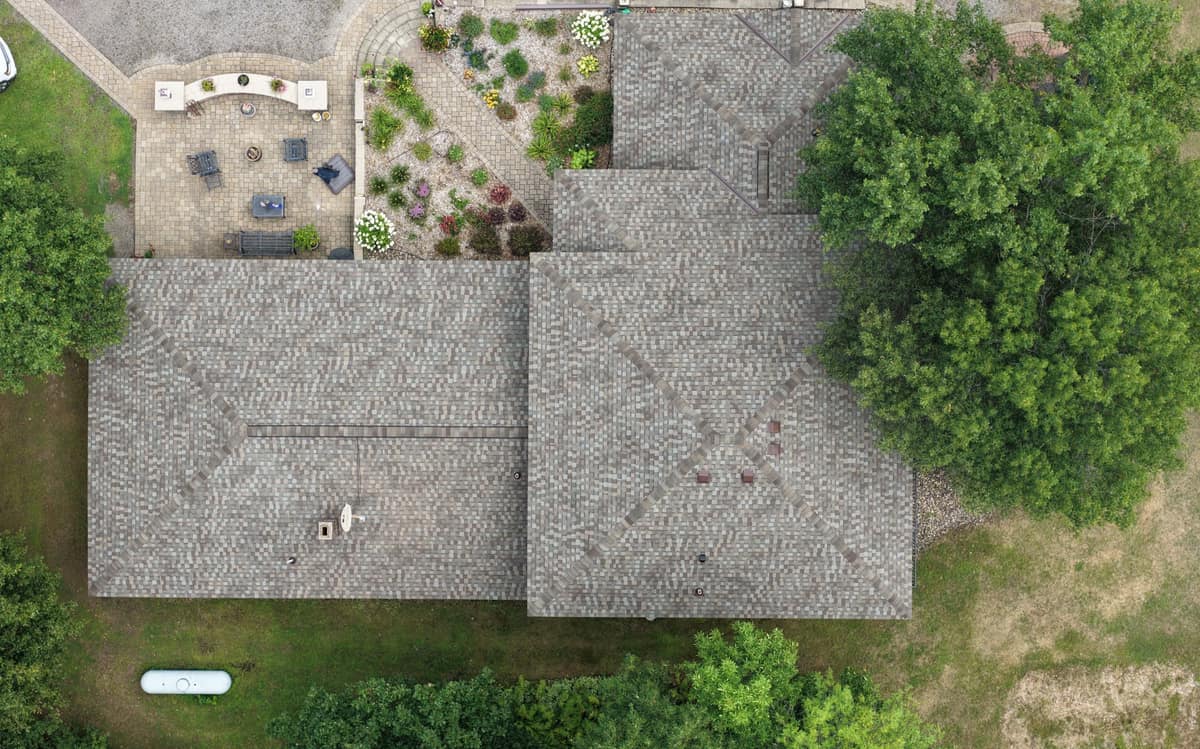 Top-down drone view of a new shingle roof over a brick ranch home in St. Augusta, MN
