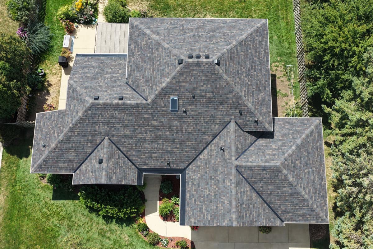 Top-down drone view of a new hip roof with skylight in St. Cloud, MN