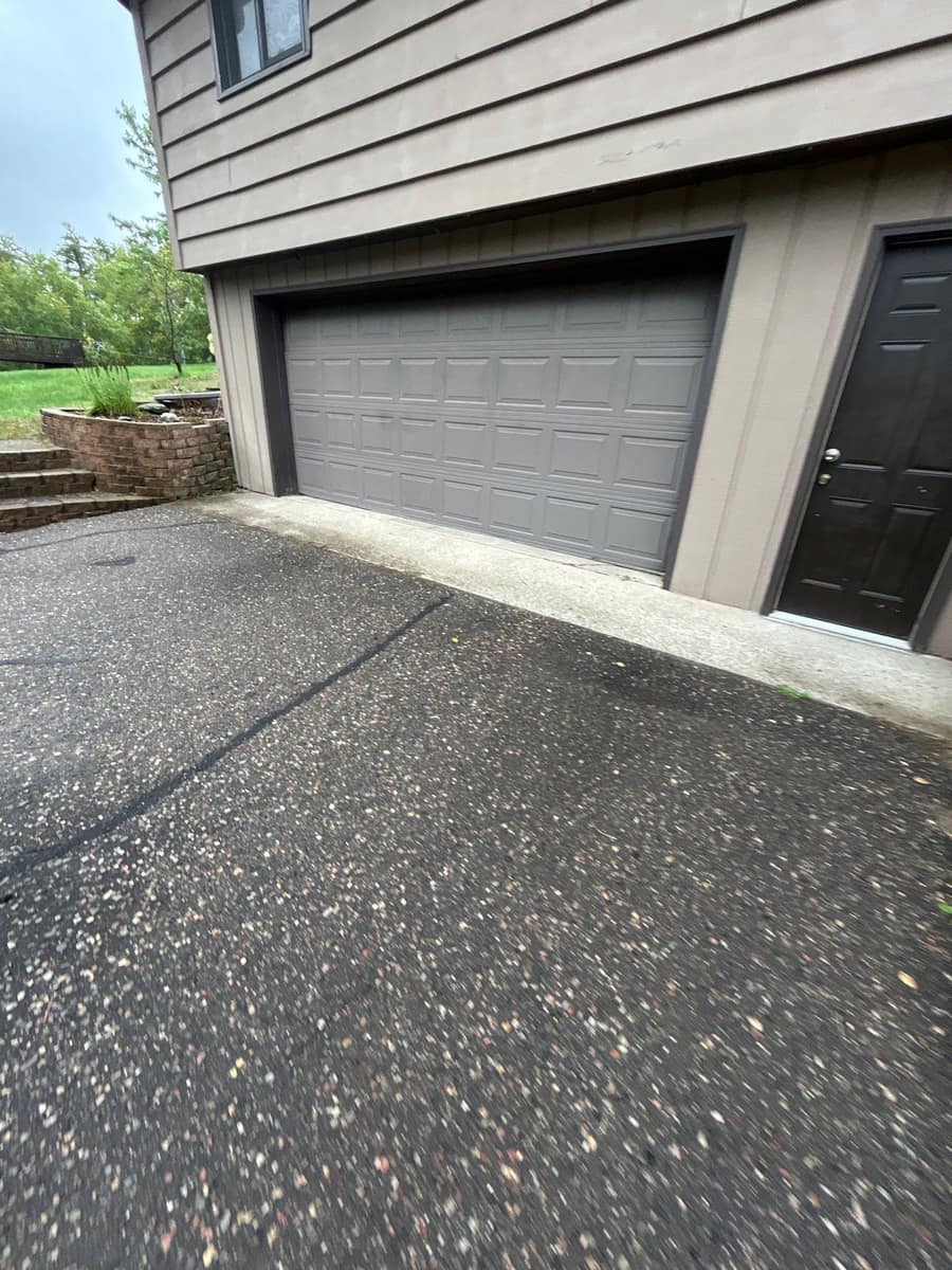 Garage end of the Baxter home with new dark fascia above the door