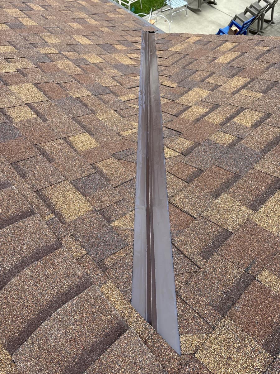 New brown blend shingles with metal valley flashing on the Brainerd roof