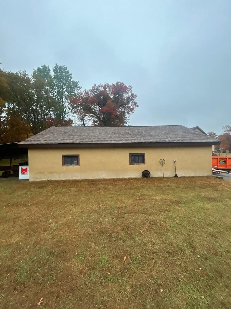 Stucco building in Brainerd with a finished brown blend shingle roof