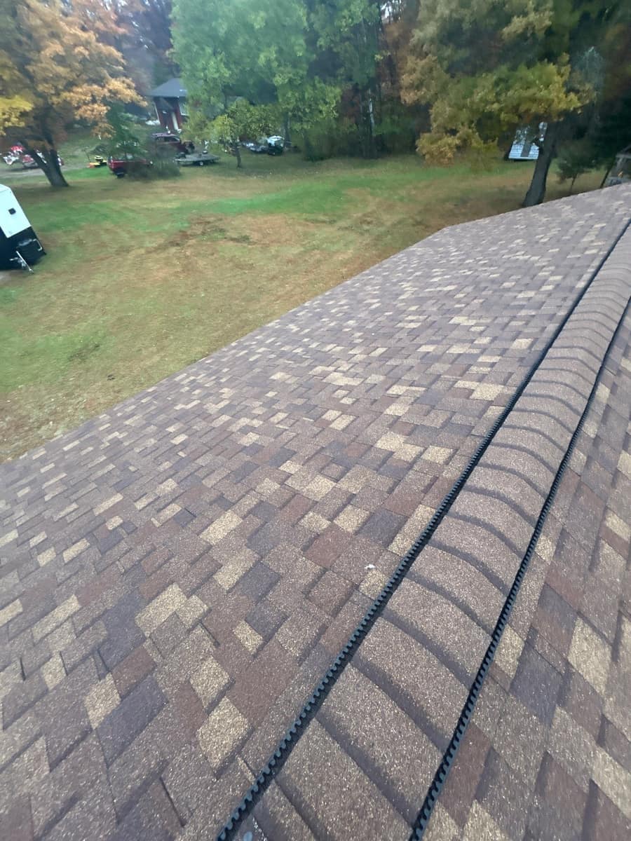 New brown blend architectural shingles with ridge vent along the peak in Brainerd