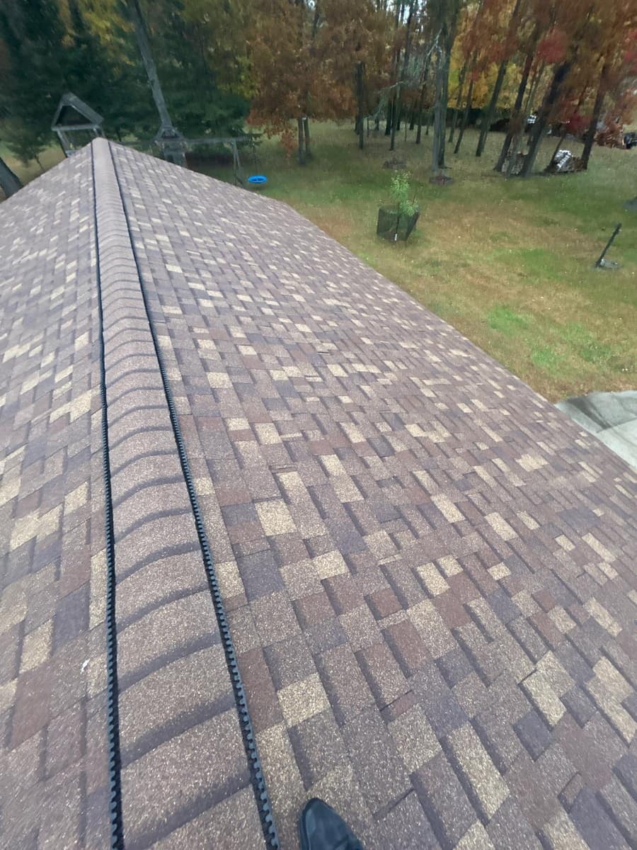 Ridge vent capped with new shingles running the length of the Brainerd roof