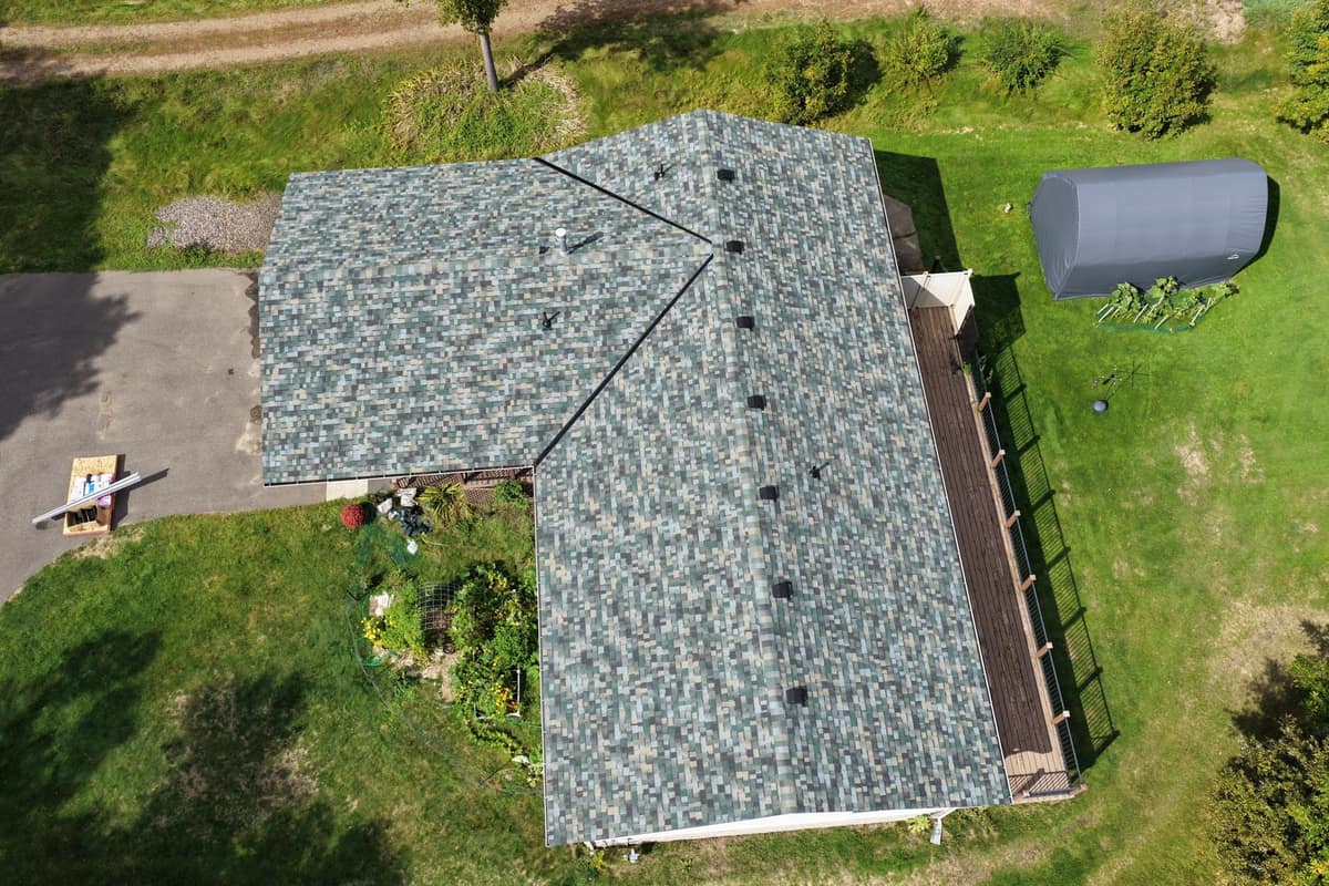 Overhead drone view of the new shingle roof with ridge vents and roof vents in Brainerd