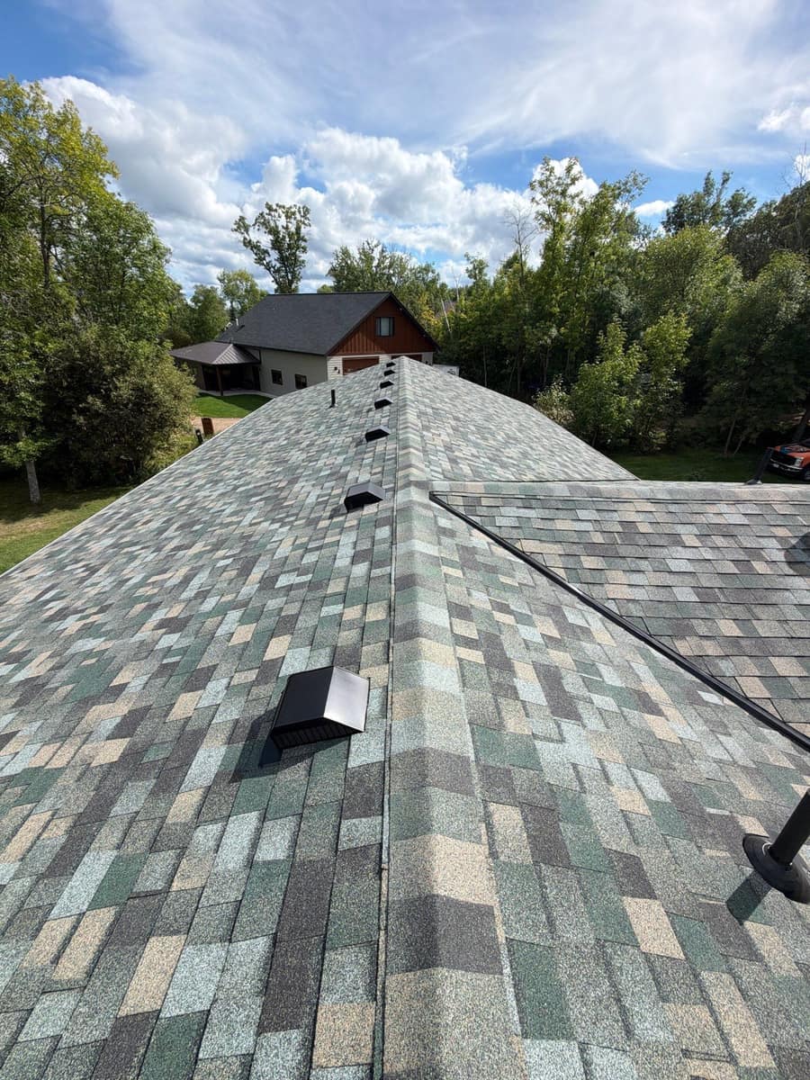 New shingles and roof vent along a hip on the Brainerd home