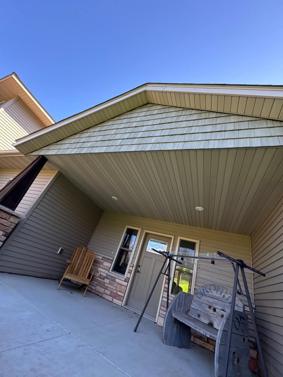 Covered front entry with stone veneer and a deep gable roof on the Kimball home