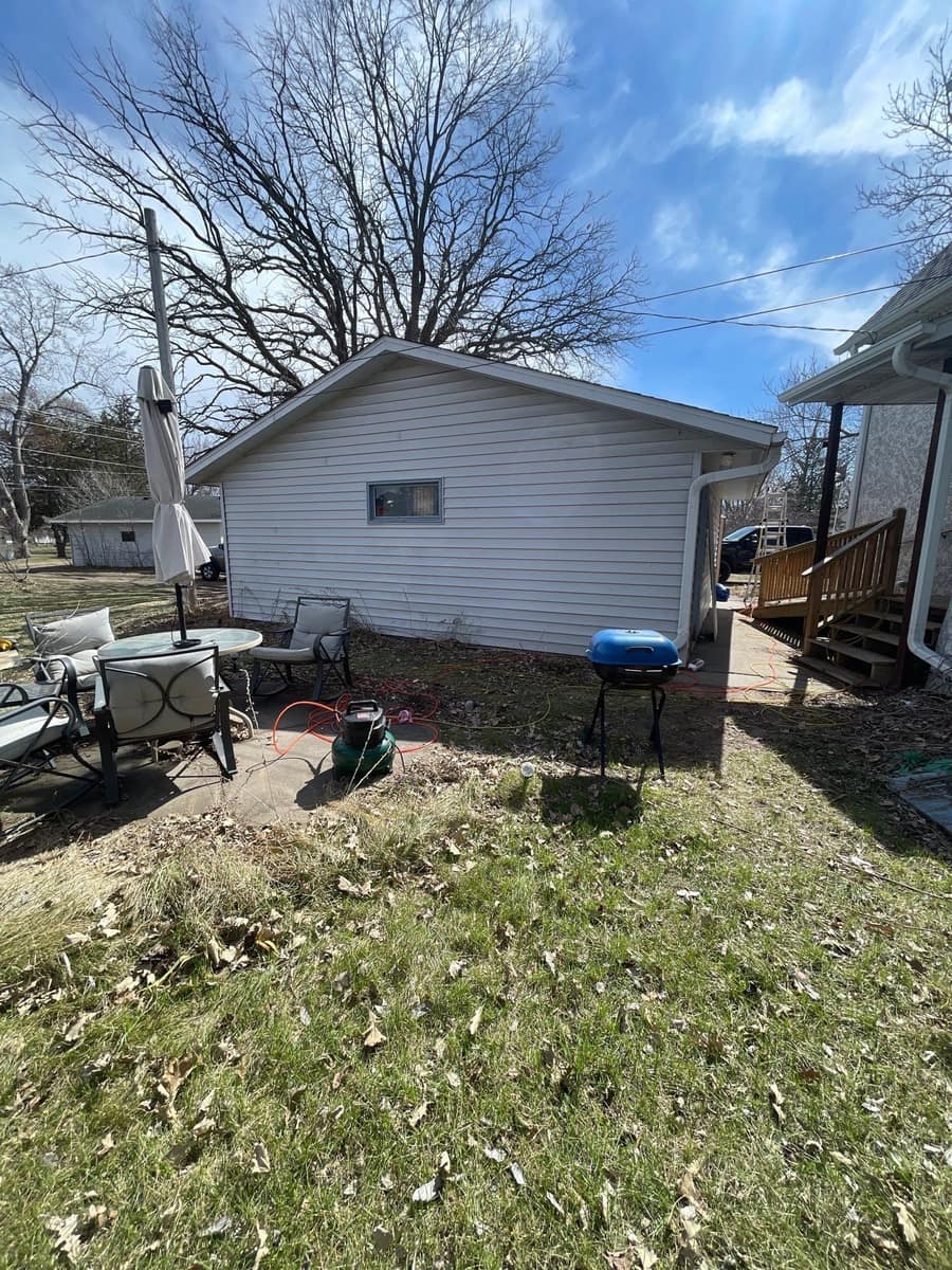Back yard view of the Little Falls home and garage after the roof replacement