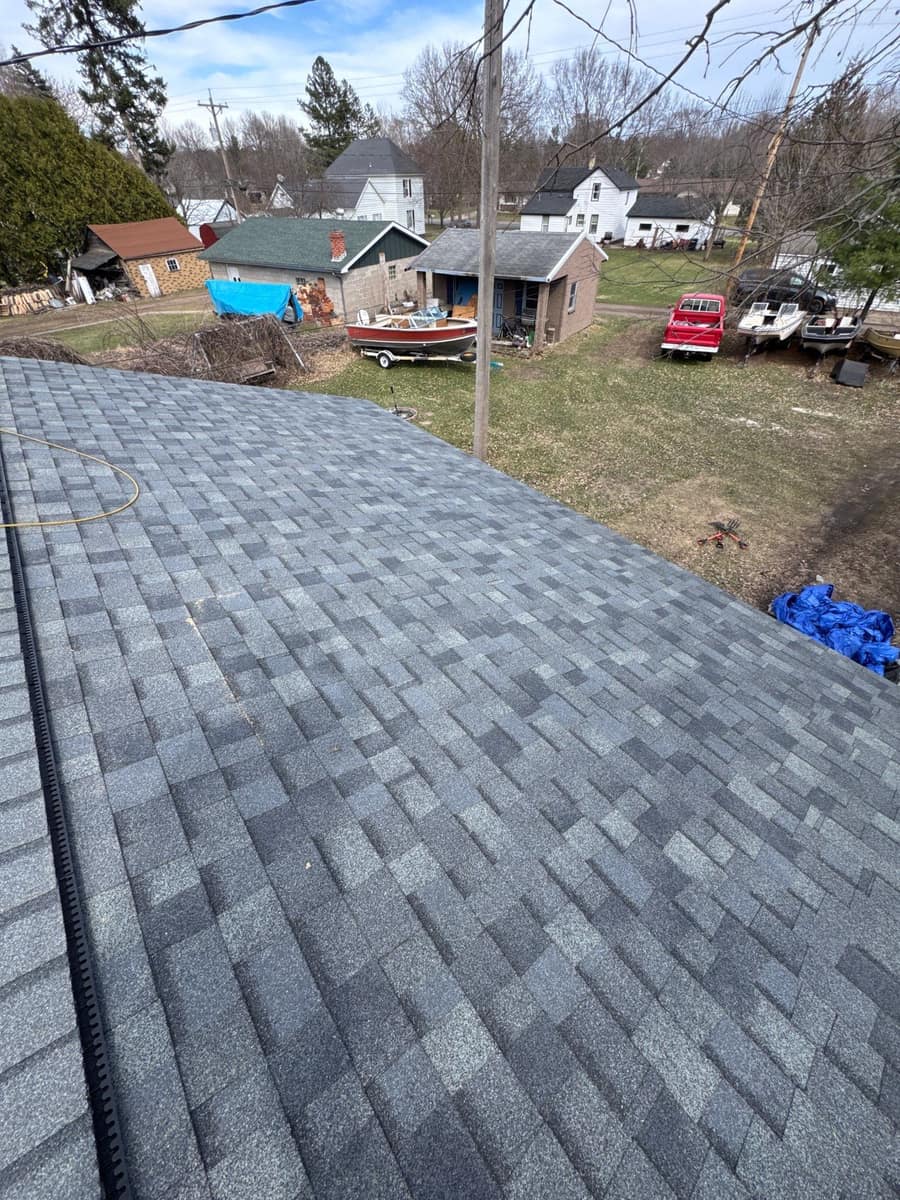 New gray architectural shingles on the Little Falls roof looking over the neighborhood