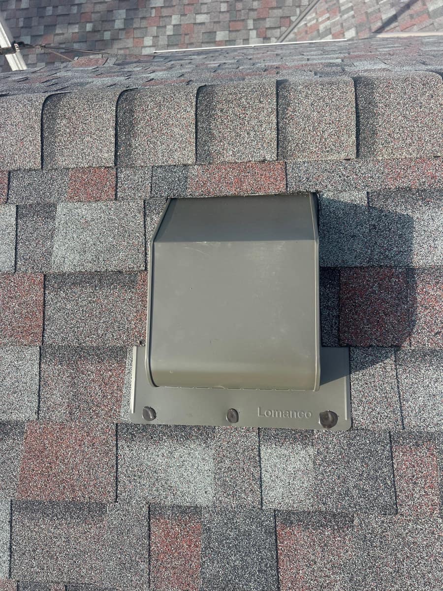 Box vent with shingles lapped over its flange on the new roof in Milaca, MN