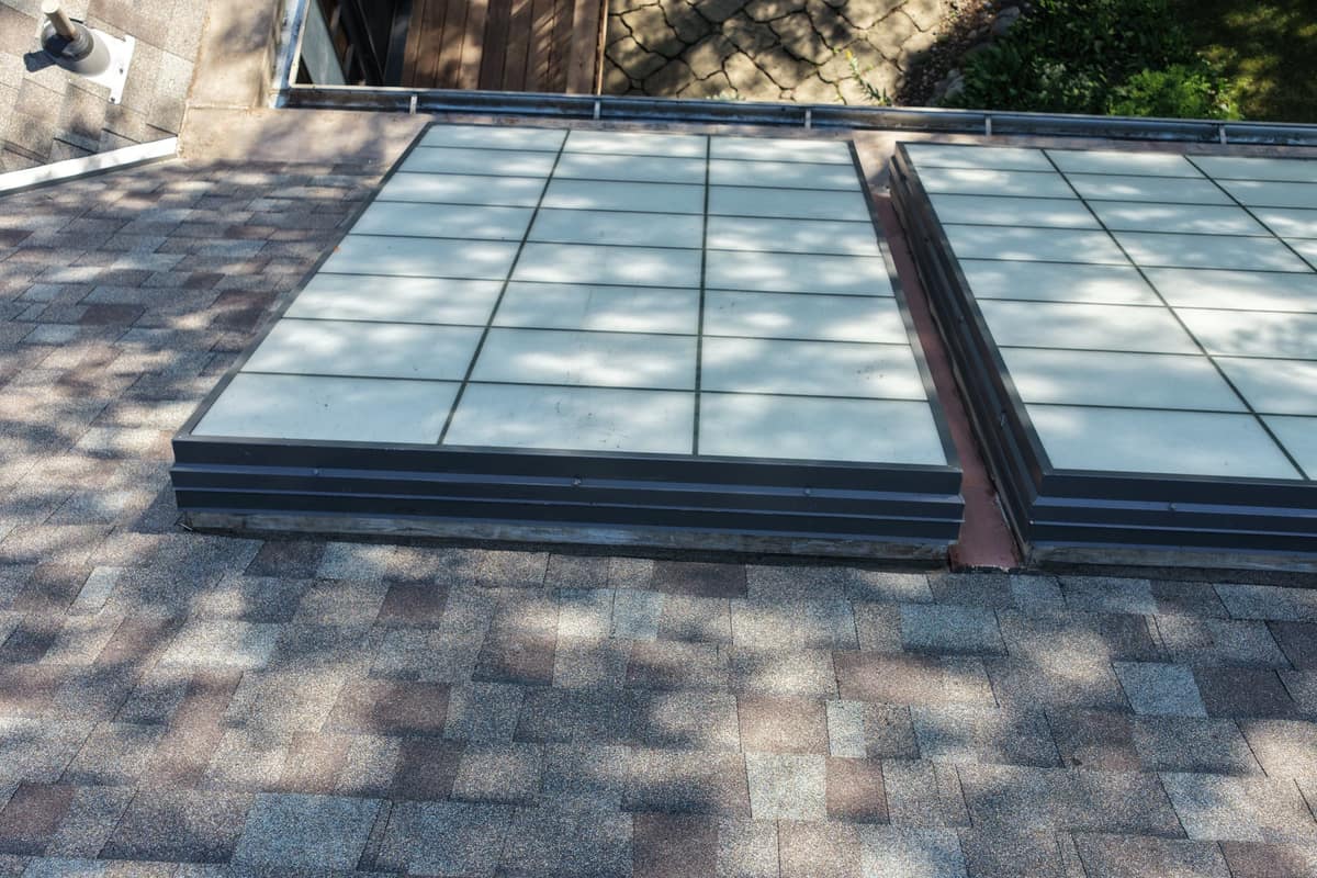 Large glass skylights set in the new shingle roof of the Minnetonka home