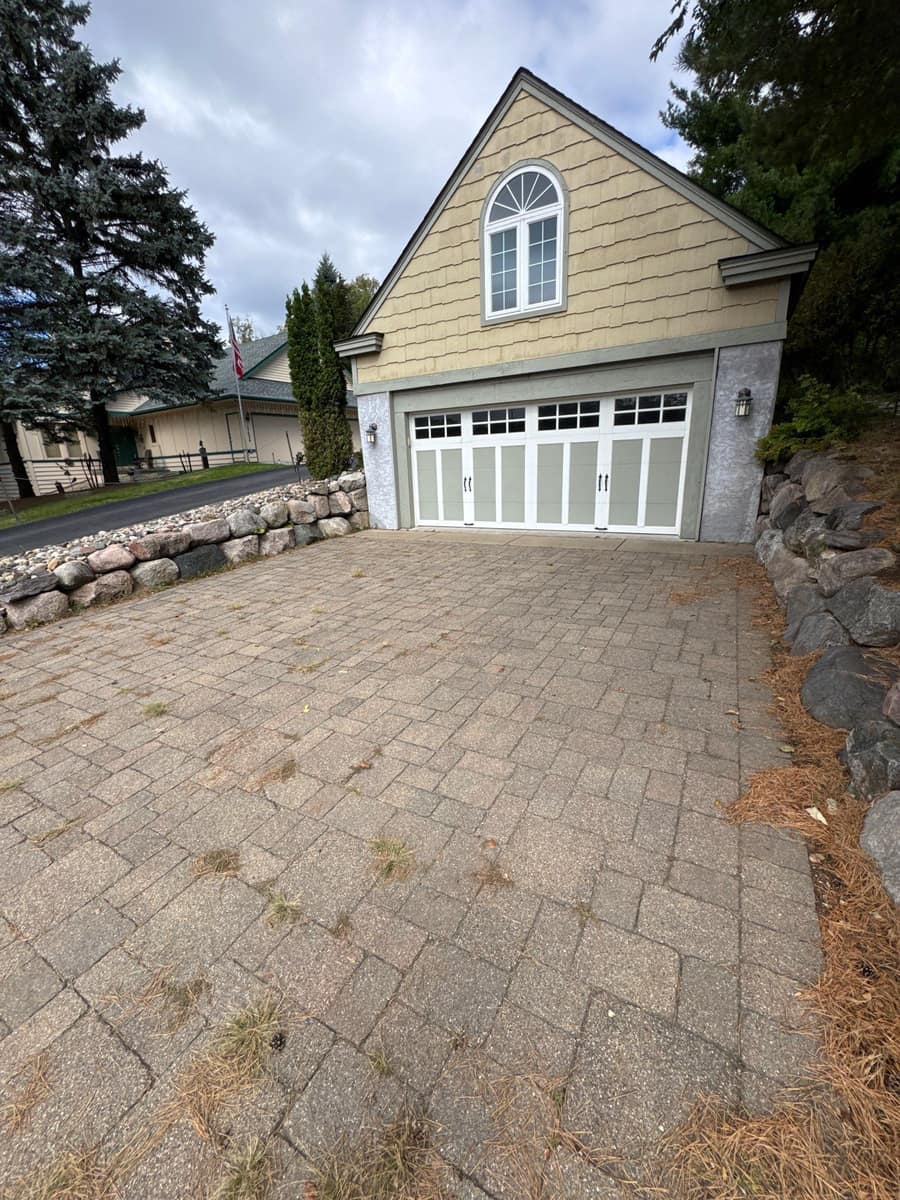 Detached garage with an arched window and new roof at the Minnetonka property