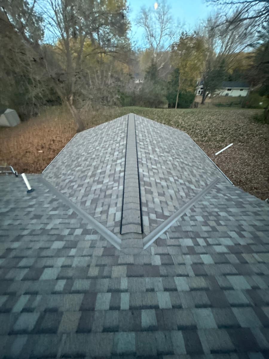 New shingle roof with a ridge vent running down the hip in Minnetonka