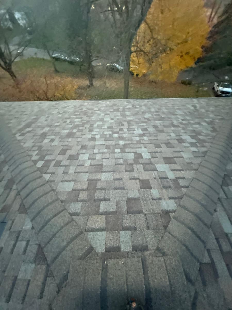 Hip roof section with new shingles looking out over the yard in Minnetonka