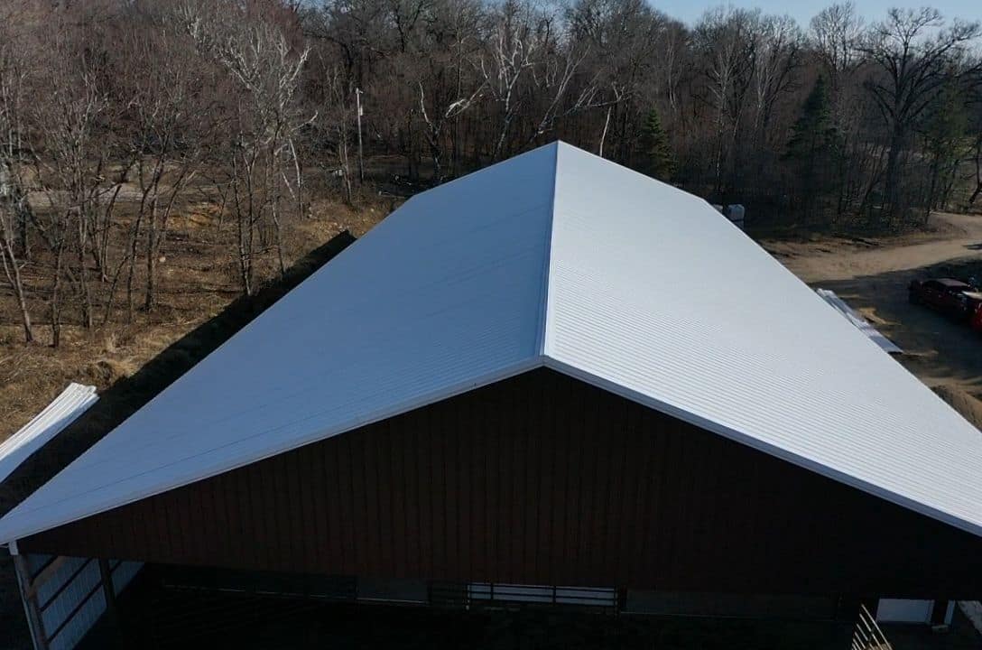 Drone view of a new light gray steel roof on a large outbuilding in Monticello, MN