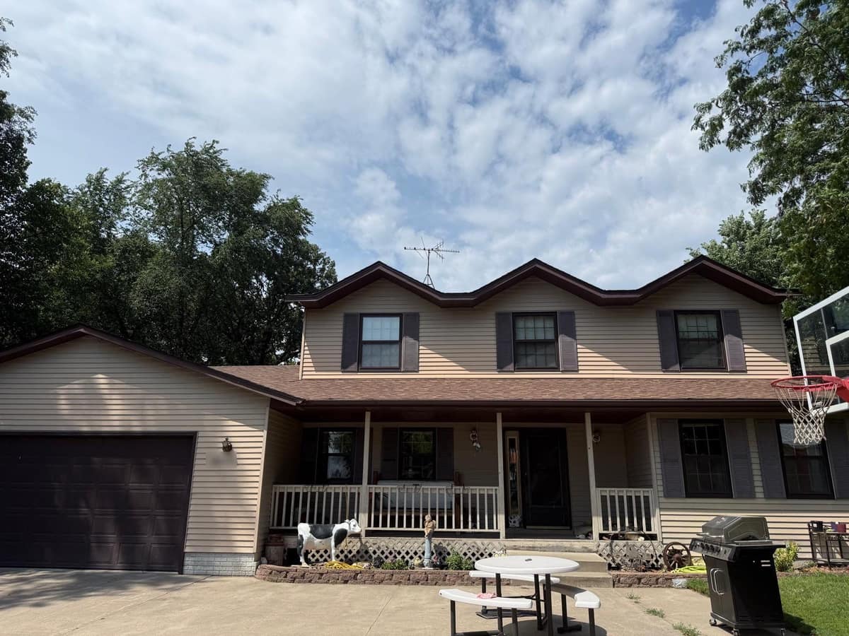 Two-story Monticello home with a covered front porch and a new brown shingle roof