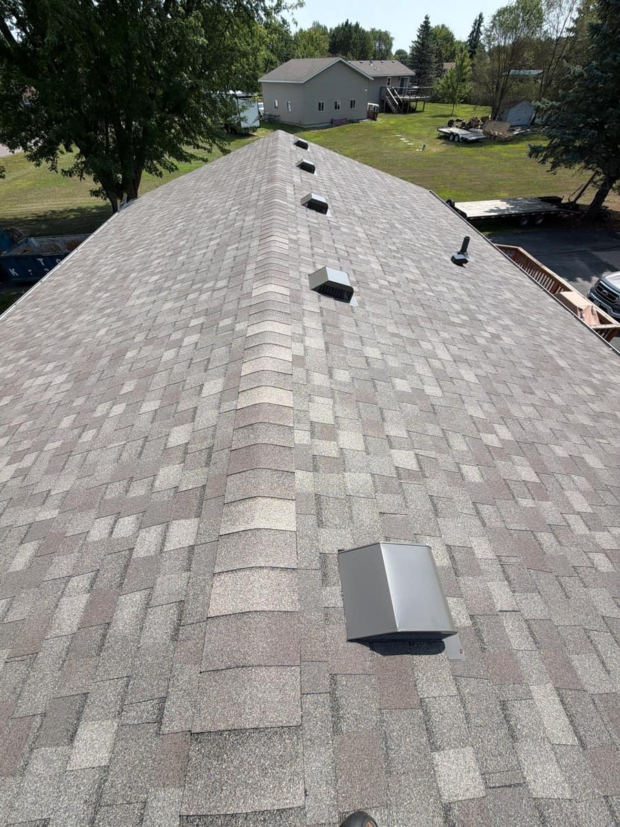 New gray shingles along the ridge with new roof vents in Otsego