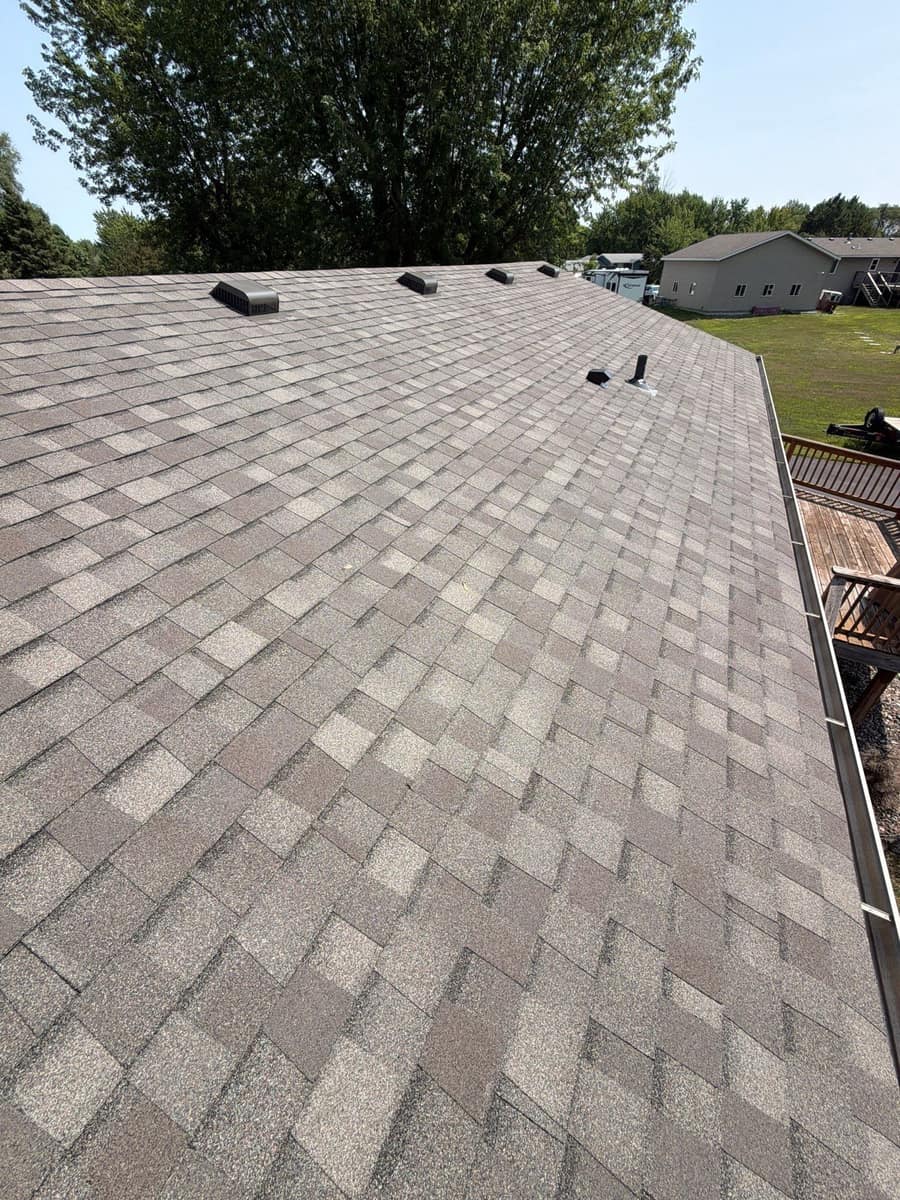 Wide view across the new shingle roof surface in Otsego