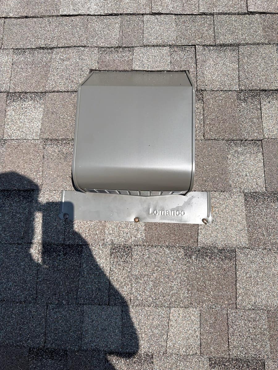 Close view of a new roof vent set in gray shingles in Otsego