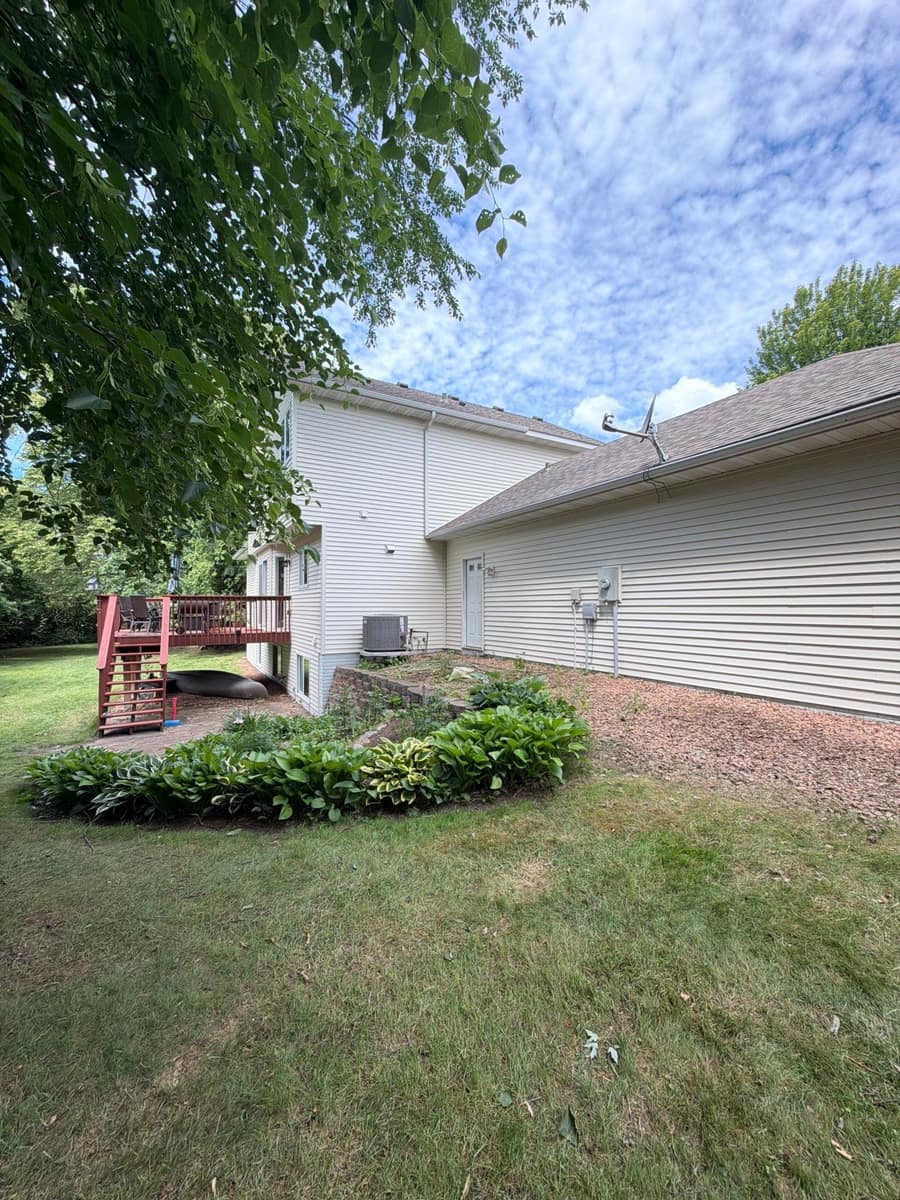 Long side of an Otsego, MN home with new cream vinyl siding