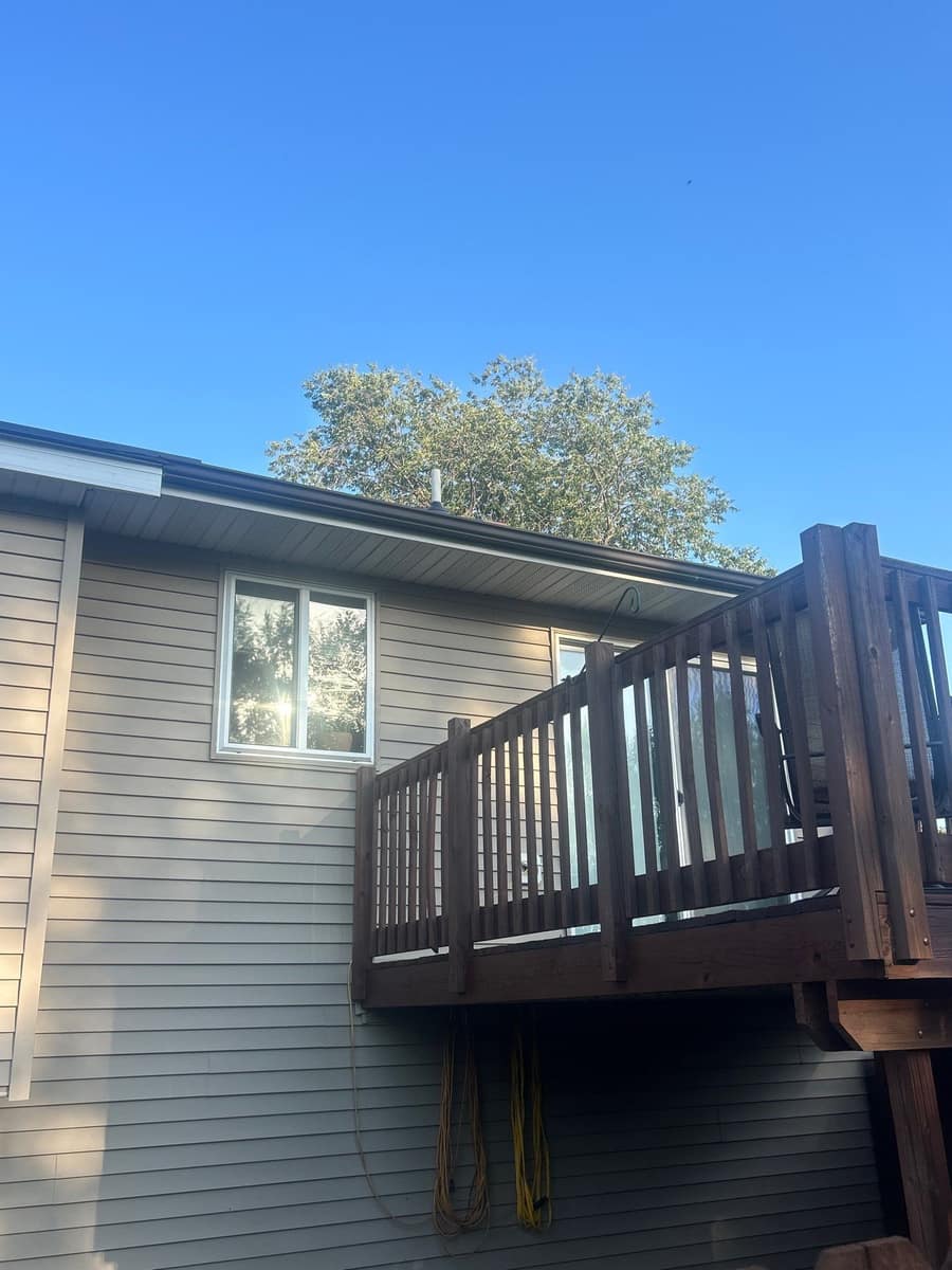 Stained wood deck on the back of the Rice home under the new roof line