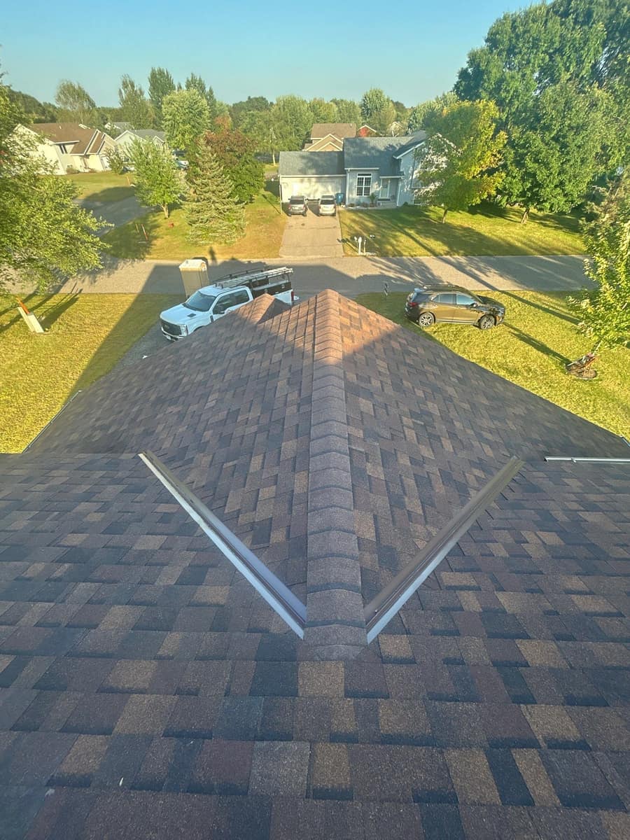 Front gable of the Rice home with two strips of valley metal running down the new shingles
