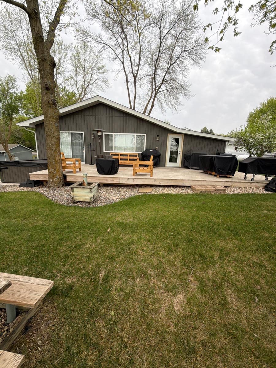 Back deck of the Richmond home with the new roof line above the gray siding