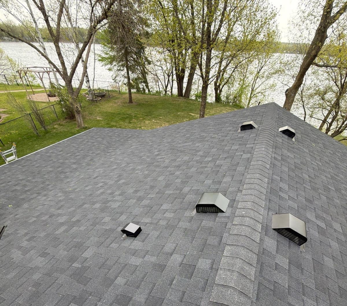 Box vents on the new dark gray roof, with the lake beyond, in Richmond