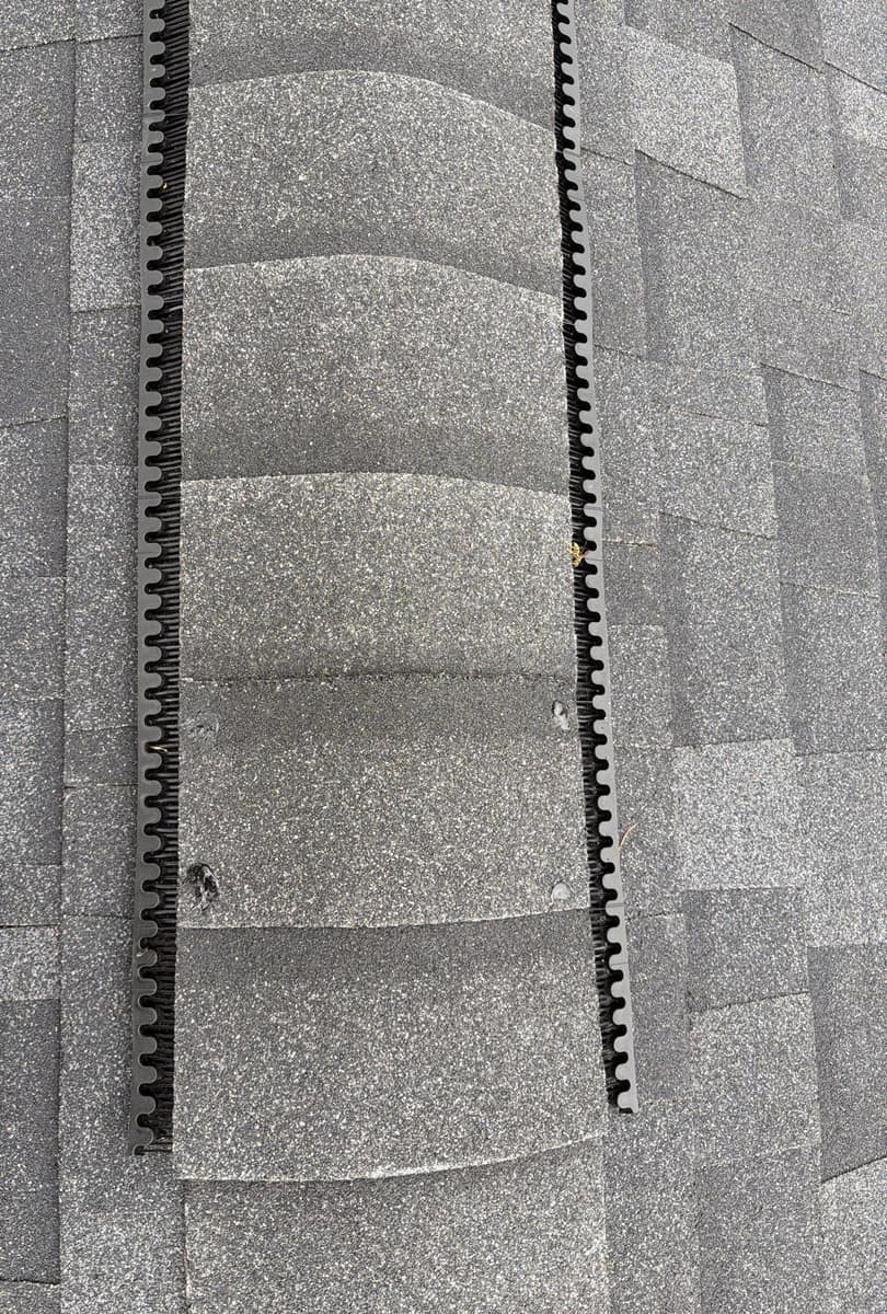 Close view of cap shingles nailed over the ridge vent on the new Richmond roof