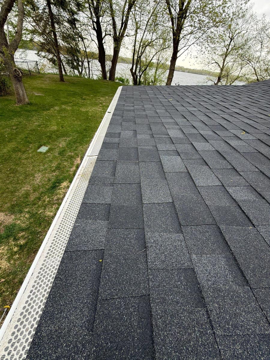 New dark gray shingles running to the eave on the lake side of the Richmond home