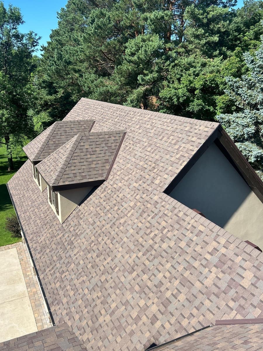 New brown blend shingle roof with dormers on a Sartell, MN home near the river