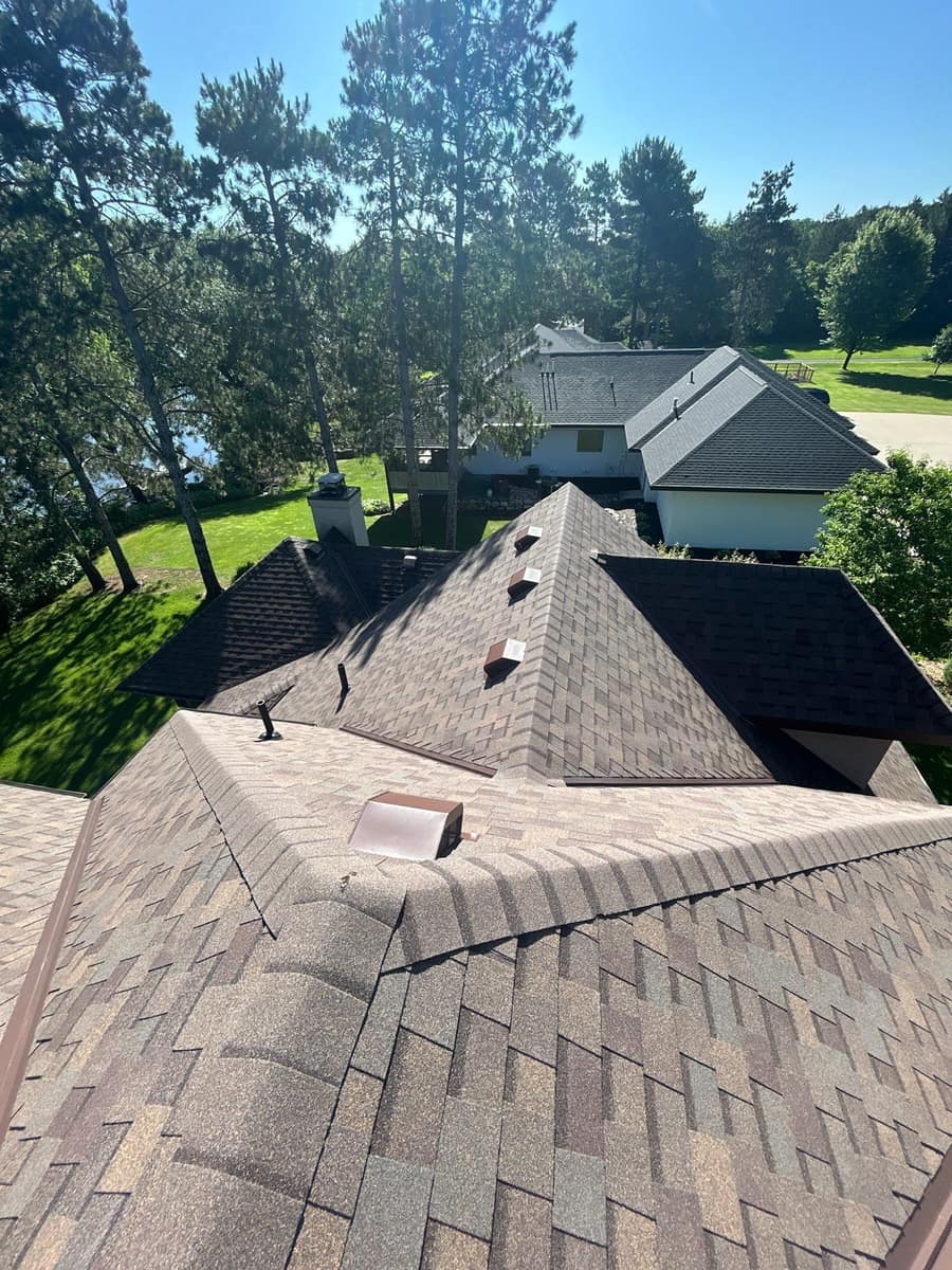 New shingle ridges and brown roof vents over the Sartell home