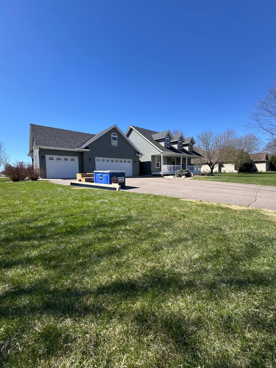 Single-story Sartell home with gray siding and a new shingle roof seen from the yard