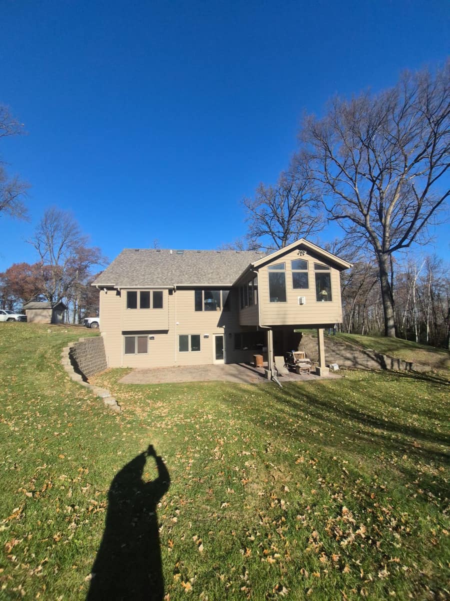Back of the St. Augusta walkout home with the new shingle roof and a patio below