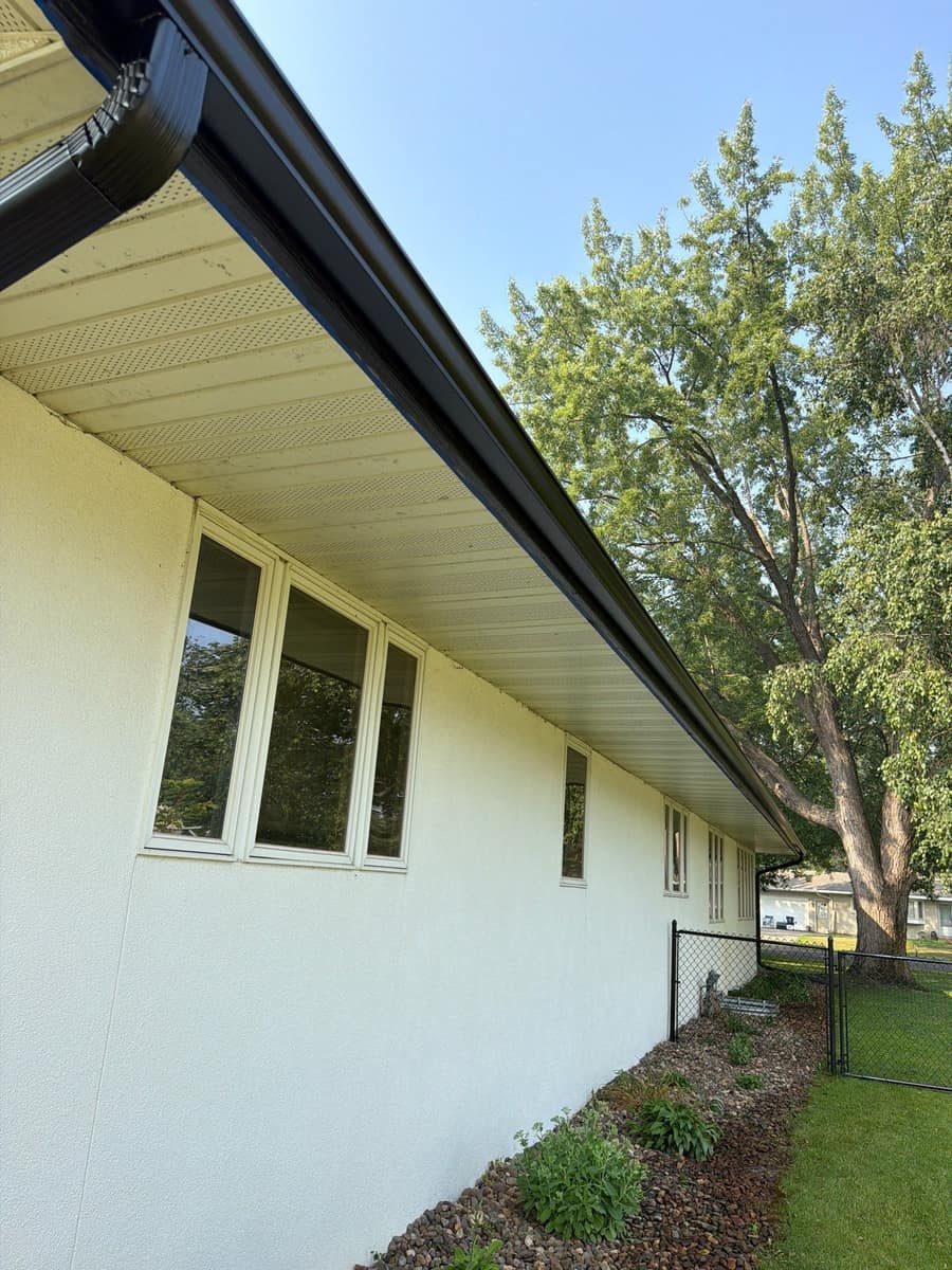 New dark gutter and white soffit running the length of the St. Cloud home