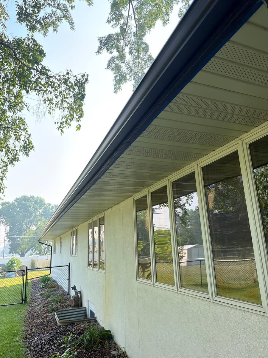 New black gutter line along the eave above a row of windows in St. Cloud