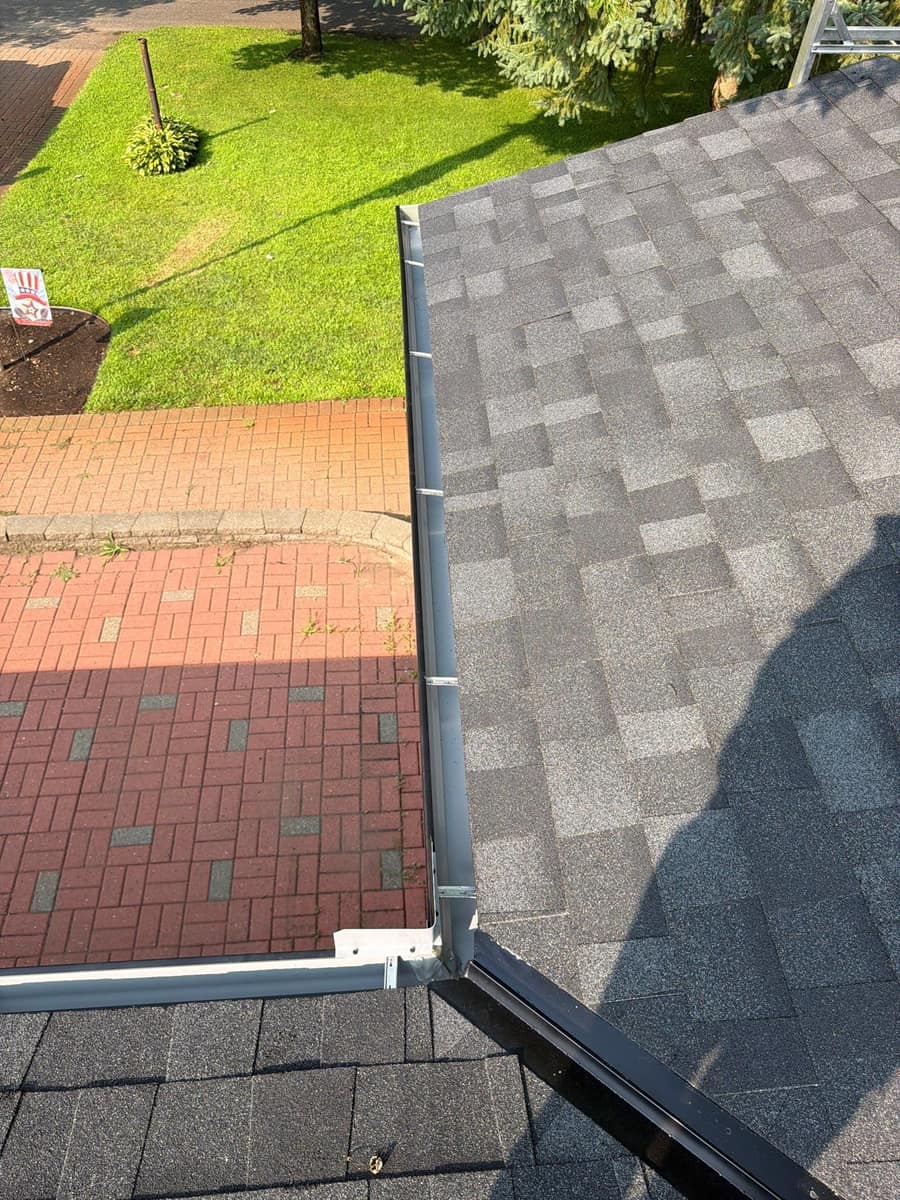 New shingles and gutter above the brick patio of the St. Cloud home