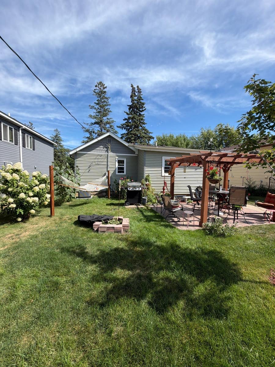 Back yard and pergola of the St. Cloud home under the new roof